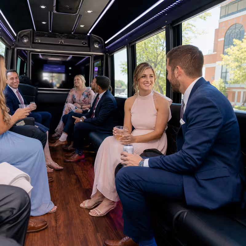 Wedding guests seated inside a Trenton party bus