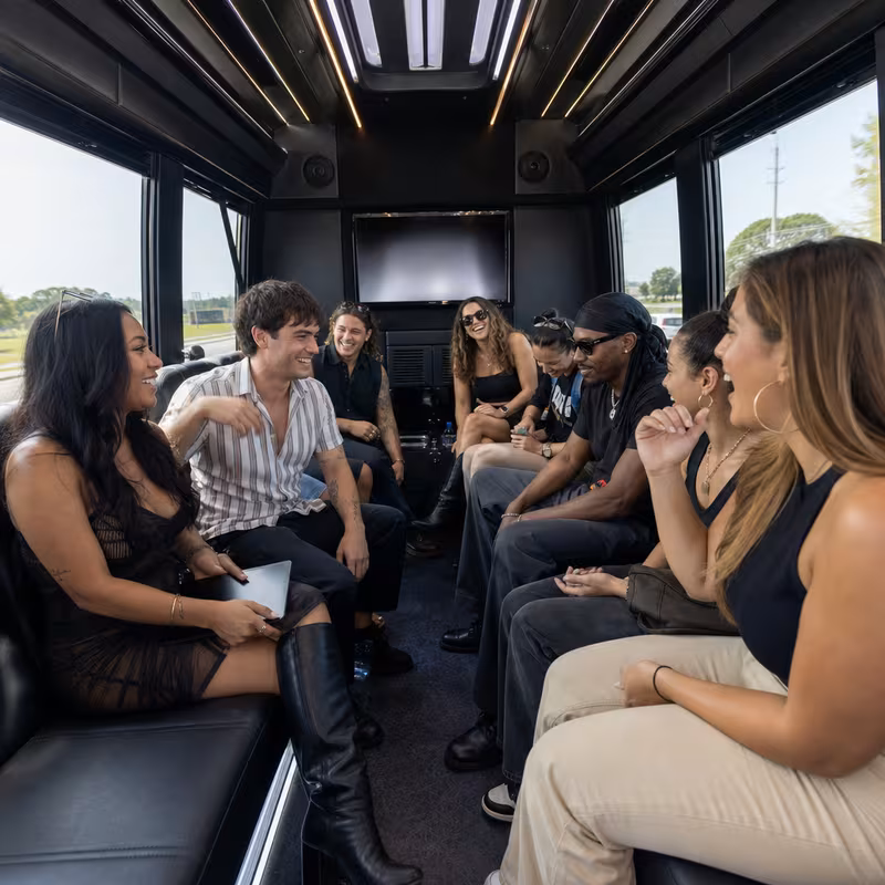 Group boarding a white charter bus for Concert Transportation transportation in Trenton