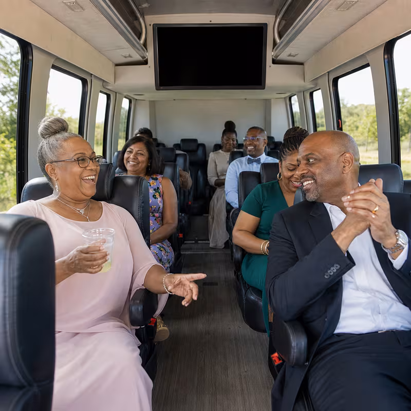 Group boarding a white charter bus for Private Event Transportation transportation in Trenton