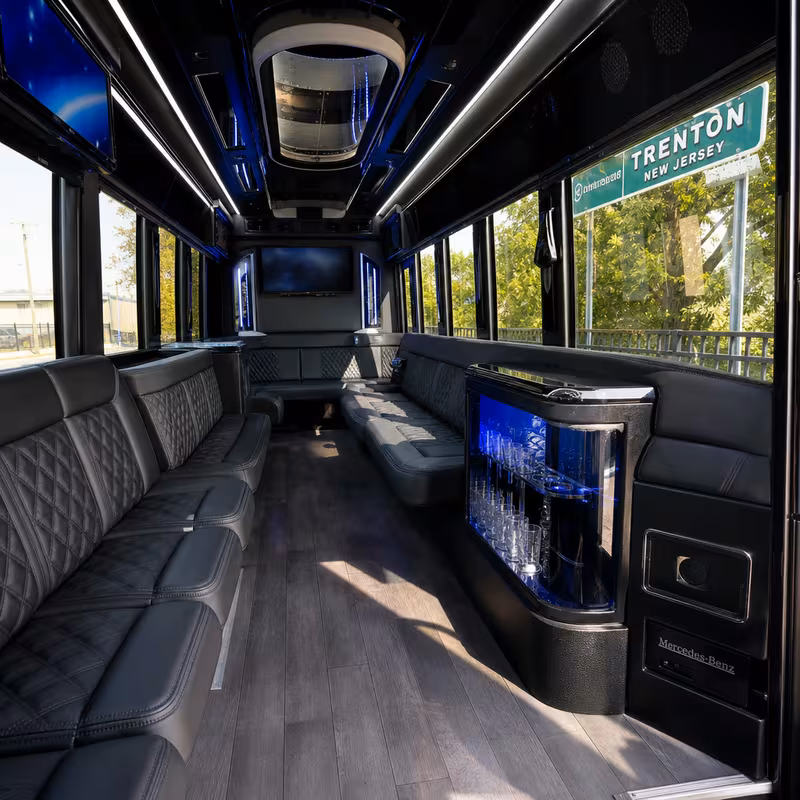 Party bus interior with wraparound leather seating and LED lighting in Trenton