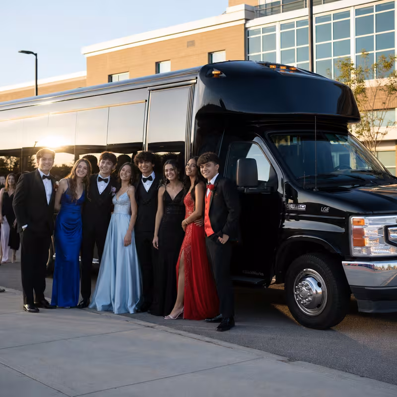 Group boarding a white charter bus for Prom & Homecoming Transportation transportation in Trenton
