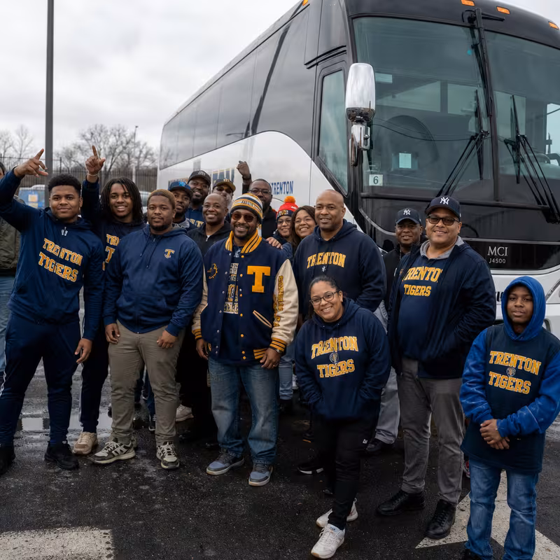 Passengers loading luggage while boarding an Trenton group shuttle