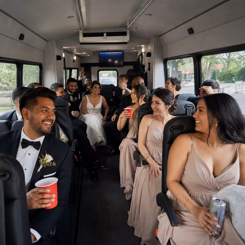 Group boarding a white charter bus for Wedding Transportation transportation in Trenton